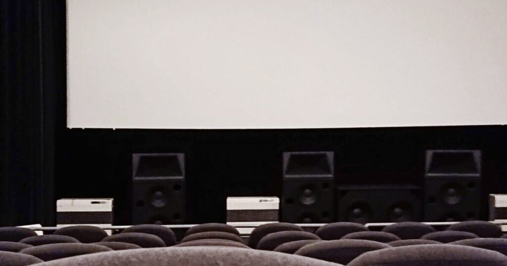 大型スクリーンとスピーカーが並ぶ映画館内